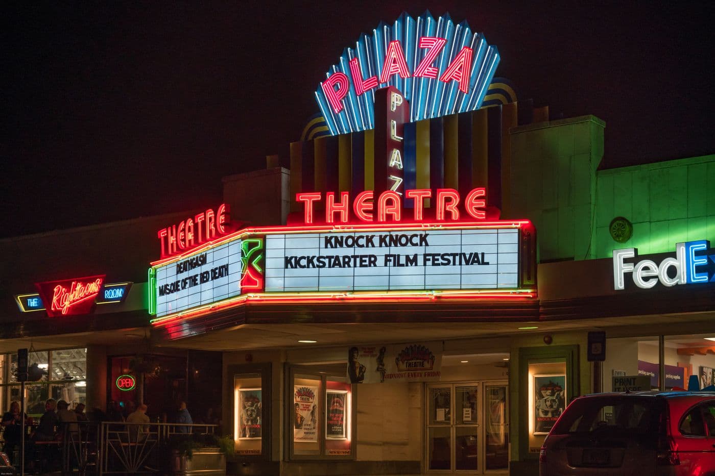 The Plaza Theatre on Ponce de Leon Avenue in Atlanta at night, its art deco facade and marquee lit in neon.