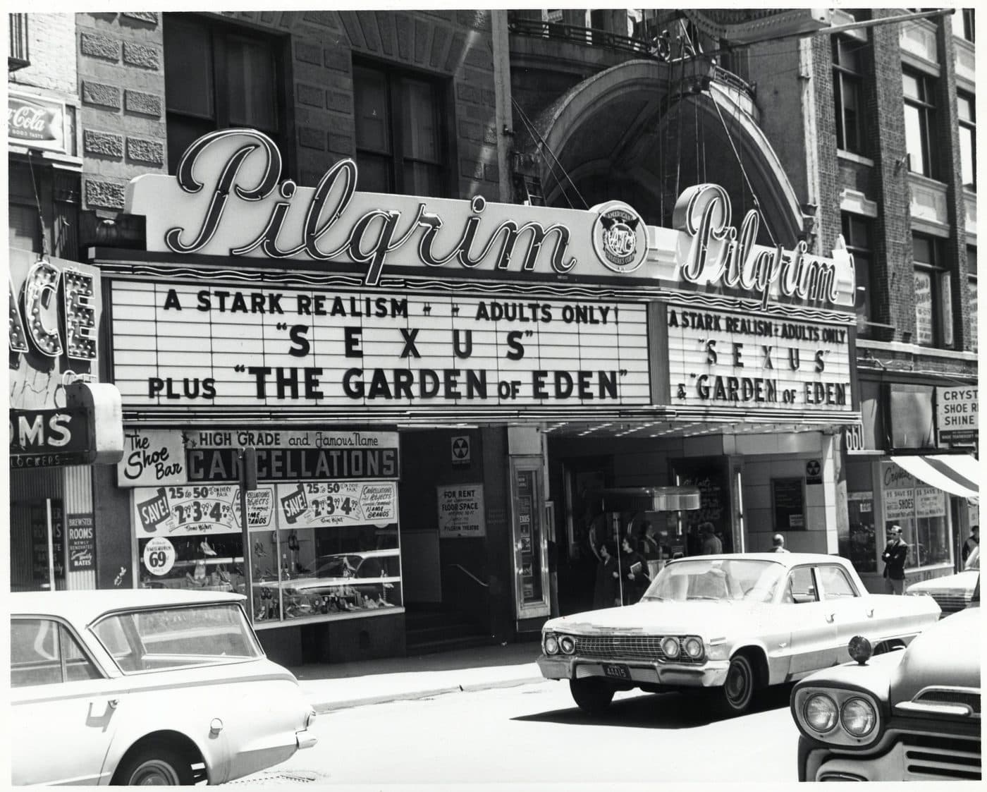 Black and white photograph of the Pilgrim Theatre marquee on Washington Street, Boston, reading A STARK REALISM, ADULTS ONLY, SEXUS plus THE GARDEN OF EDEN, with early 1960s cars parked outside.